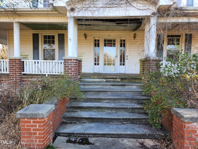 view of exterior entry with a porch