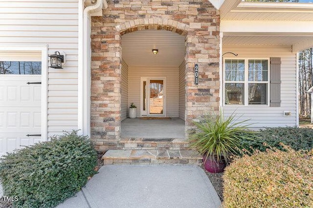 doorway to property with a garage