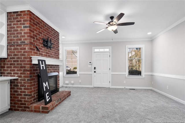 unfurnished living room with ornamental molding, plenty of natural light, and carpet flooring