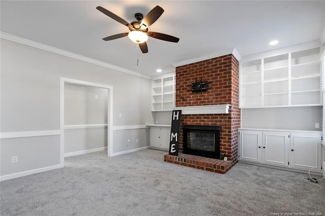 unfurnished living room featuring a fireplace, light carpet, crown molding, and ceiling fan