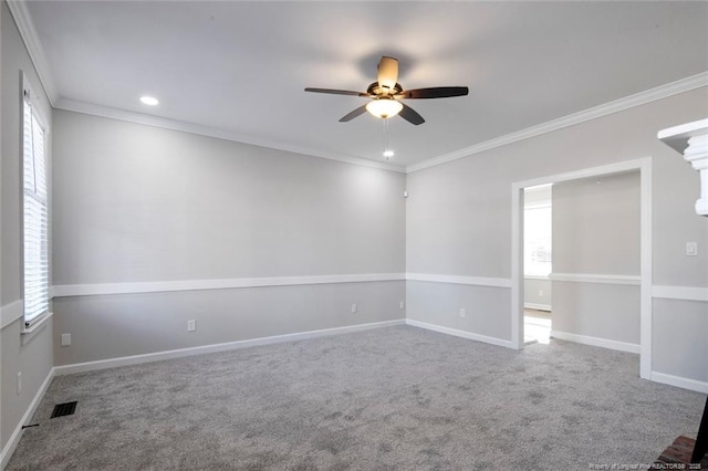 carpeted empty room with ceiling fan, crown molding, and a wealth of natural light