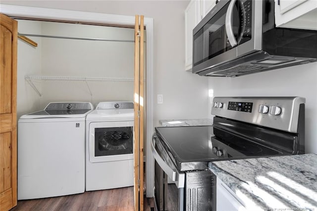 clothes washing area featuring dark hardwood / wood-style flooring and separate washer and dryer