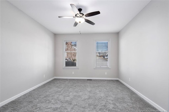 unfurnished room featuring ceiling fan and carpet