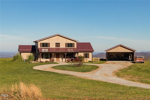 view of front of property with a mountain view, an outdoor structure, and a front yard