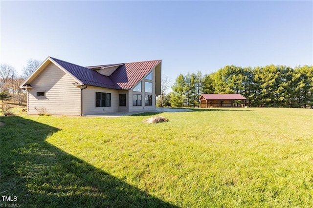 back of house with a lawn