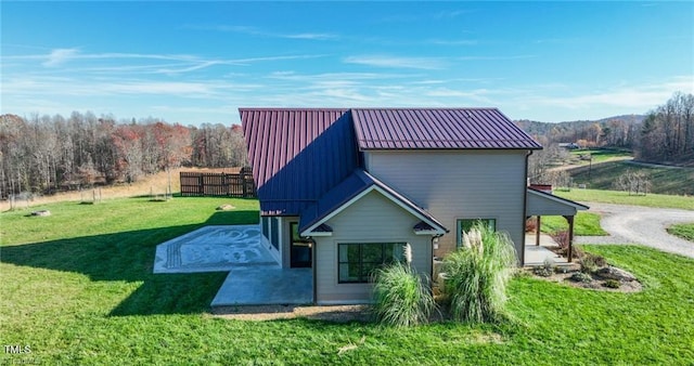 back of property featuring a lawn and a patio area