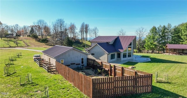 rear view of house featuring a lawn