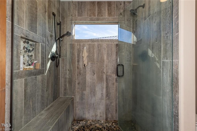 bathroom featuring a shower with shower door