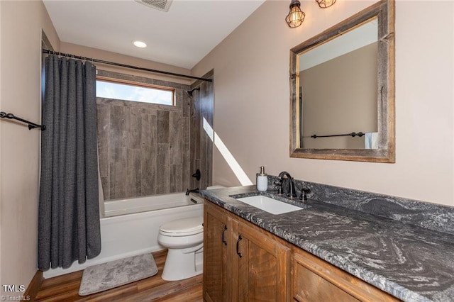 full bathroom with vanity, hardwood / wood-style flooring, toilet, and shower / bathtub combination with curtain