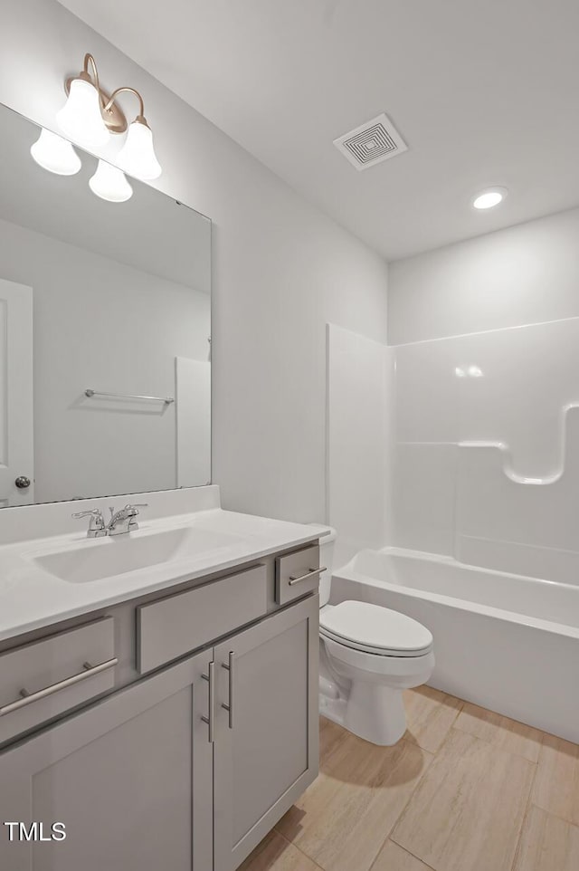 full bathroom featuring vanity, bathing tub / shower combination, toilet, and hardwood / wood-style flooring