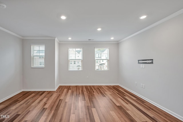 unfurnished room with hardwood / wood-style floors and ornamental molding