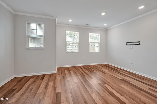 unfurnished room with light wood-type flooring and ornamental molding