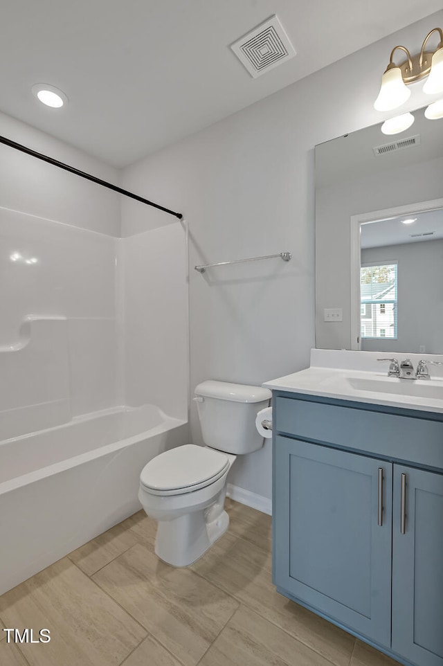 full bathroom featuring bathtub / shower combination, vanity, and toilet