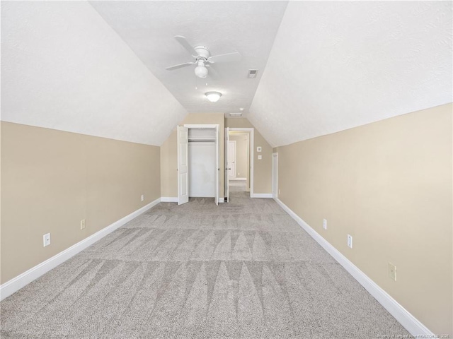 bonus room featuring ceiling fan, light colored carpet, and vaulted ceiling