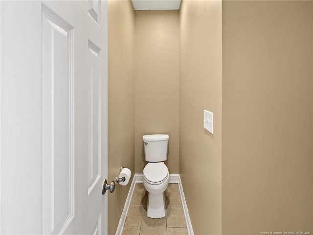 bathroom with tile patterned flooring and toilet