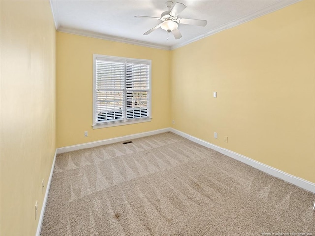 carpeted spare room with ceiling fan and ornamental molding