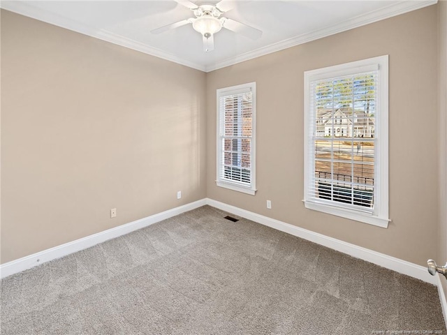 spare room featuring carpet, ceiling fan, and crown molding