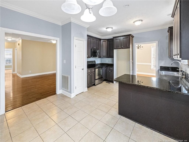 kitchen featuring appliances with stainless steel finishes, ornamental molding, dark brown cabinets, sink, and light tile patterned floors