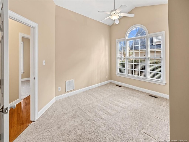 carpeted empty room with ceiling fan and lofted ceiling