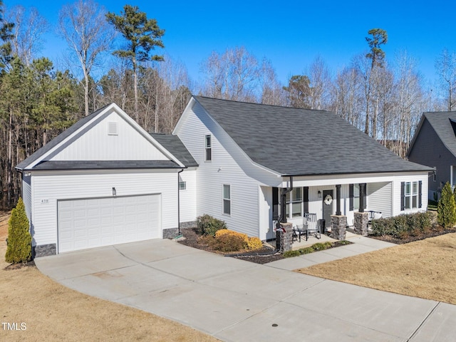 view of front facade featuring a porch and a garage