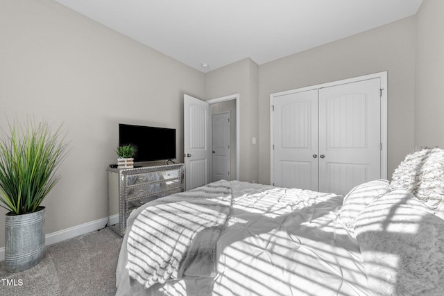 bedroom featuring light colored carpet and a closet