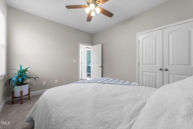 carpeted bedroom featuring ceiling fan and a closet