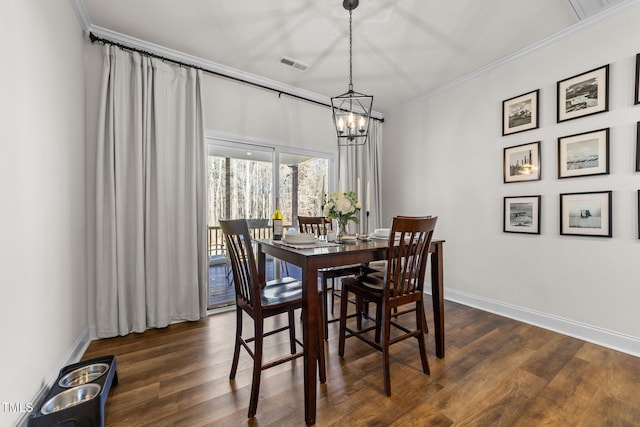 dining space featuring an inviting chandelier, dark wood-type flooring, and ornamental molding