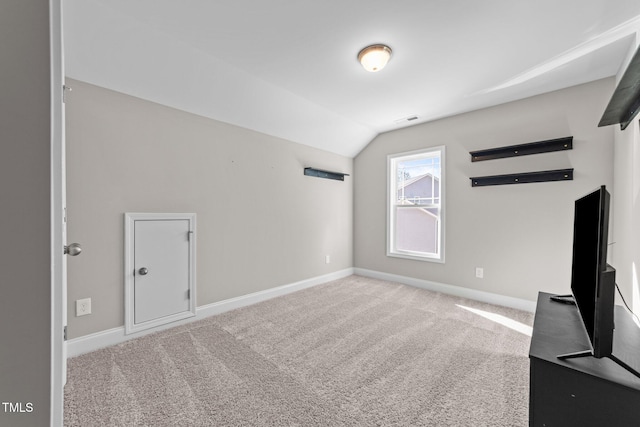 additional living space with carpet floors and vaulted ceiling