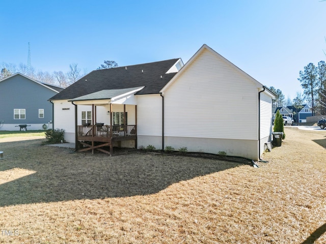 rear view of house with a lawn