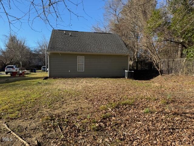 view of side of home with a lawn