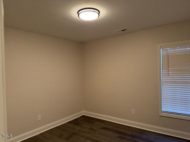 empty room featuring dark hardwood / wood-style floors