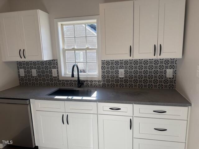 kitchen featuring a healthy amount of sunlight, white cabinetry, sink, and stainless steel dishwasher