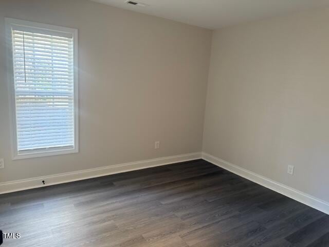 spare room featuring dark hardwood / wood-style flooring