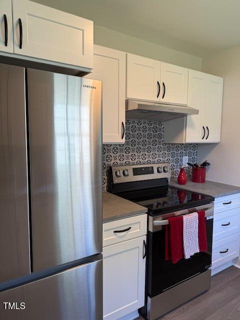 415 Sowell St, Durham, NC 27701 - kitchen featuring stainless steel appliances, under cabinet range hood, white cabinets, and dark wood-style flooring
