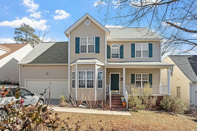 traditional-style house featuring a garage, a porch, and driveway