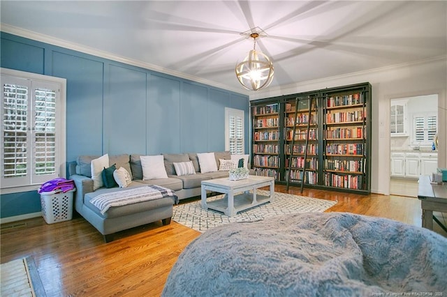 sitting room featuring hardwood / wood-style floors and ornamental molding