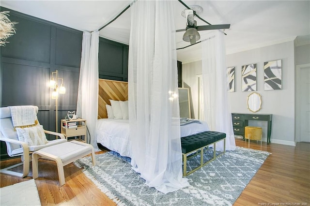 bedroom featuring crown molding and hardwood / wood-style flooring