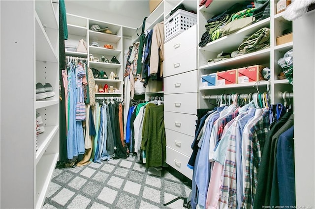 walk in closet featuring light carpet