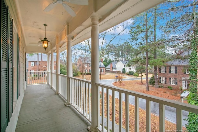 balcony with covered porch and ceiling fan