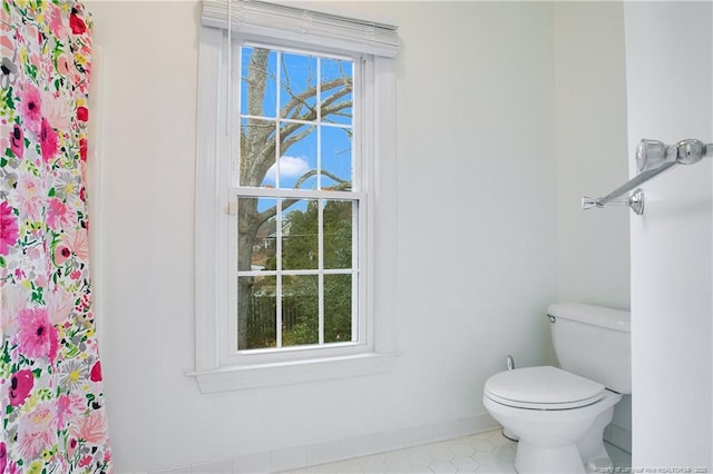 bathroom featuring toilet and a wealth of natural light