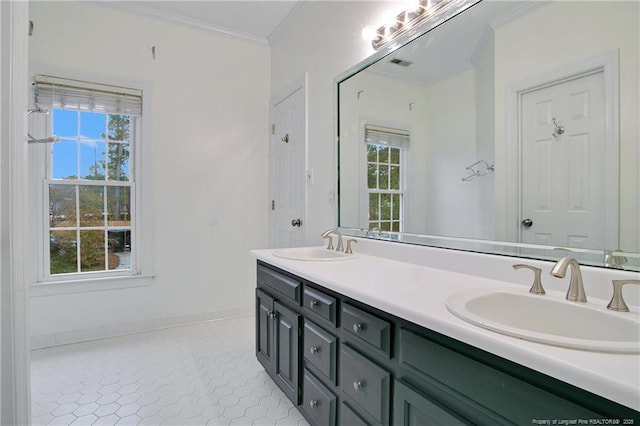 bathroom with tile patterned floors, plenty of natural light, crown molding, and vanity