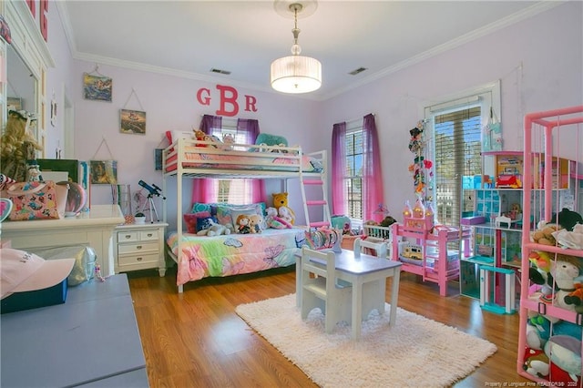 bedroom featuring crown molding and hardwood / wood-style floors