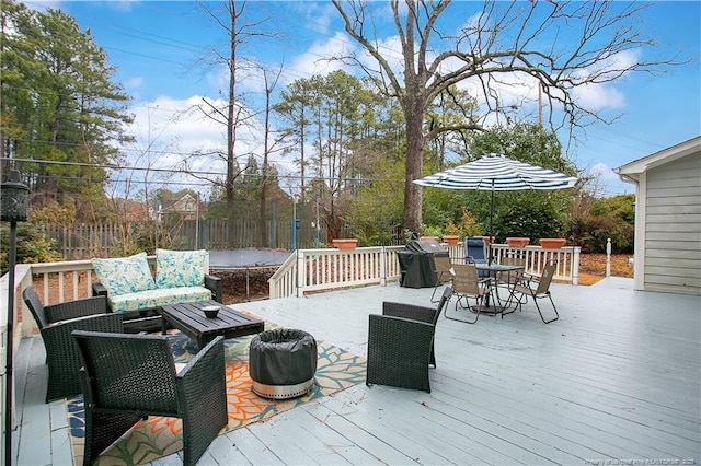 deck featuring an outdoor living space and area for grilling