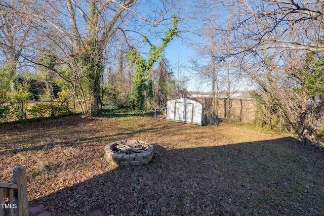 view of yard with a fire pit and a shed