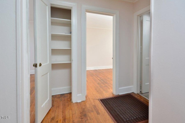 corridor with light hardwood / wood-style floors