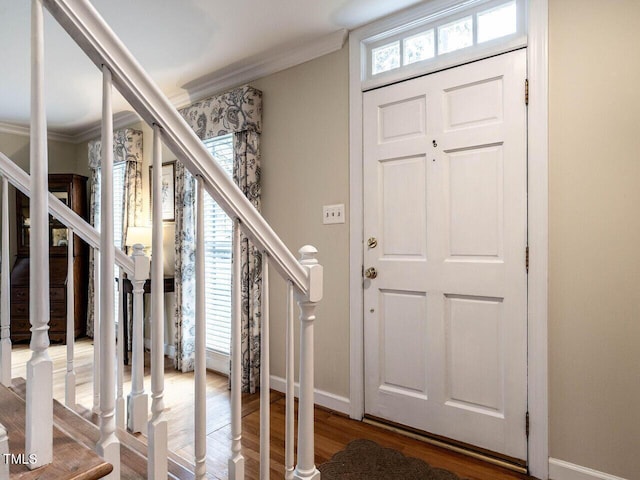 foyer with hardwood / wood-style flooring and crown molding