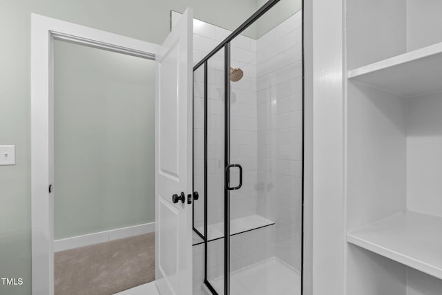 bathroom with a shower with shower door