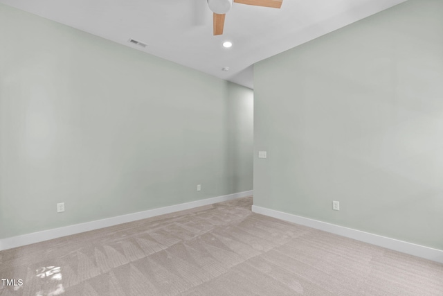 unfurnished room featuring light colored carpet and ceiling fan