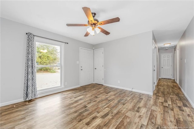 empty room featuring ceiling fan and hardwood / wood-style floors