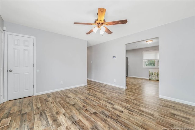 unfurnished room featuring hardwood / wood-style floors and ceiling fan